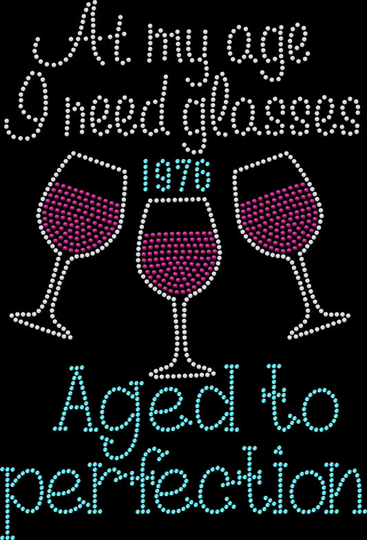 At My Age I Need Glasses Aged to Perfection rhinestone shirt featuring sparkling crystal lettering with a custom year on a soft women’s tee, perfect for milestone birthdays and funny birthday celebrations.