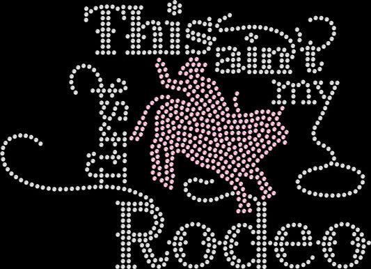 Sparkling rhinestone shirt that reads “This Ain’t My First Rodeo” on a black t-shirt, western cowgirl bling tee for women perfect for rodeos and country concerts.