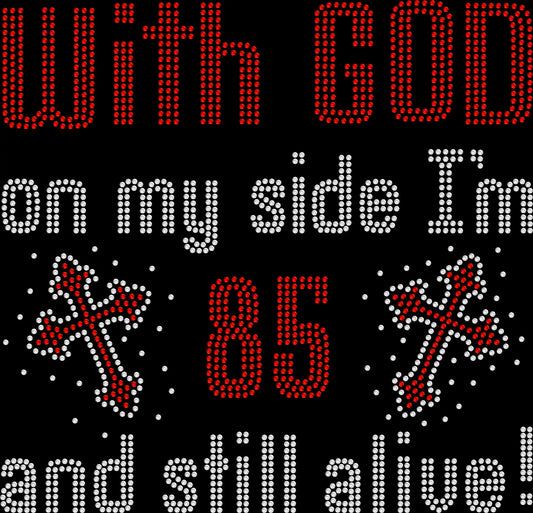 Rhinestone Christian shirt with sparkling crosses and the phrase ‘With God on My Side I’m 85 and Still Alive,’ customizable age Christian birthday bling tee.